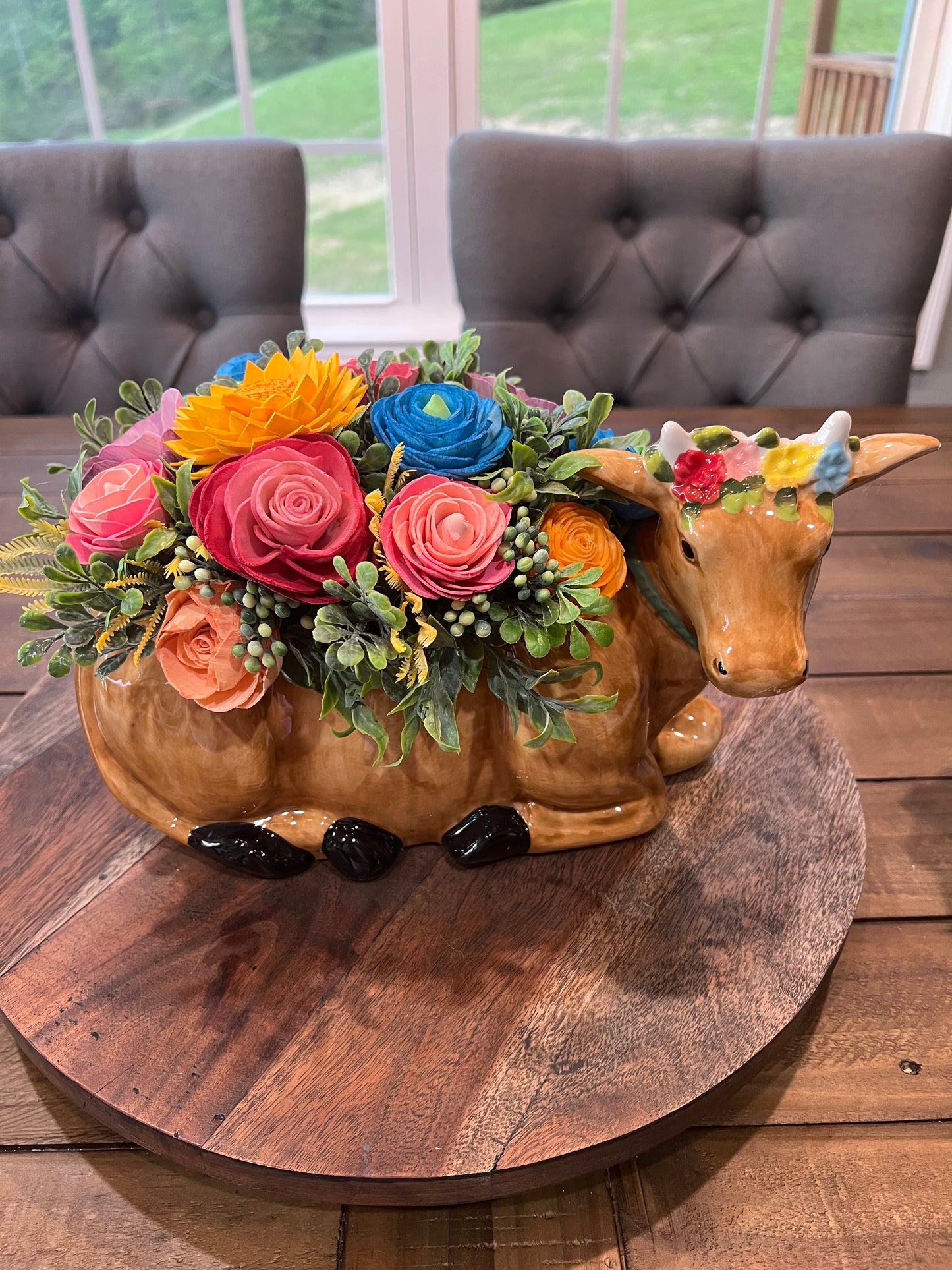 COW WITH PINK AND BLUE ORANGE AND RED WOOD FLOWERS