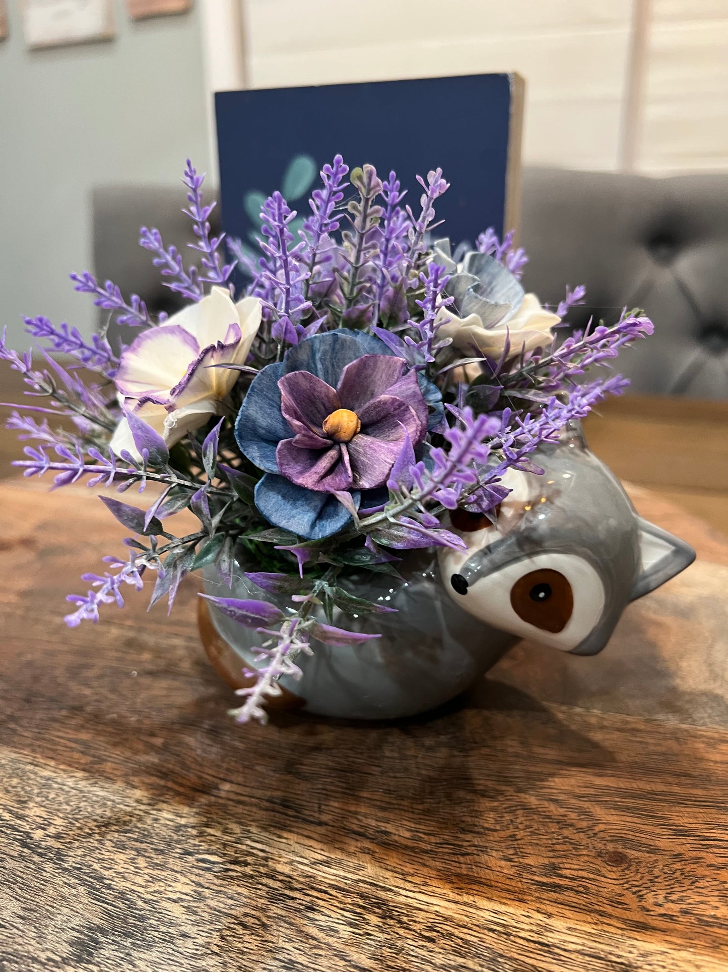 Raccoon with pansy flowers