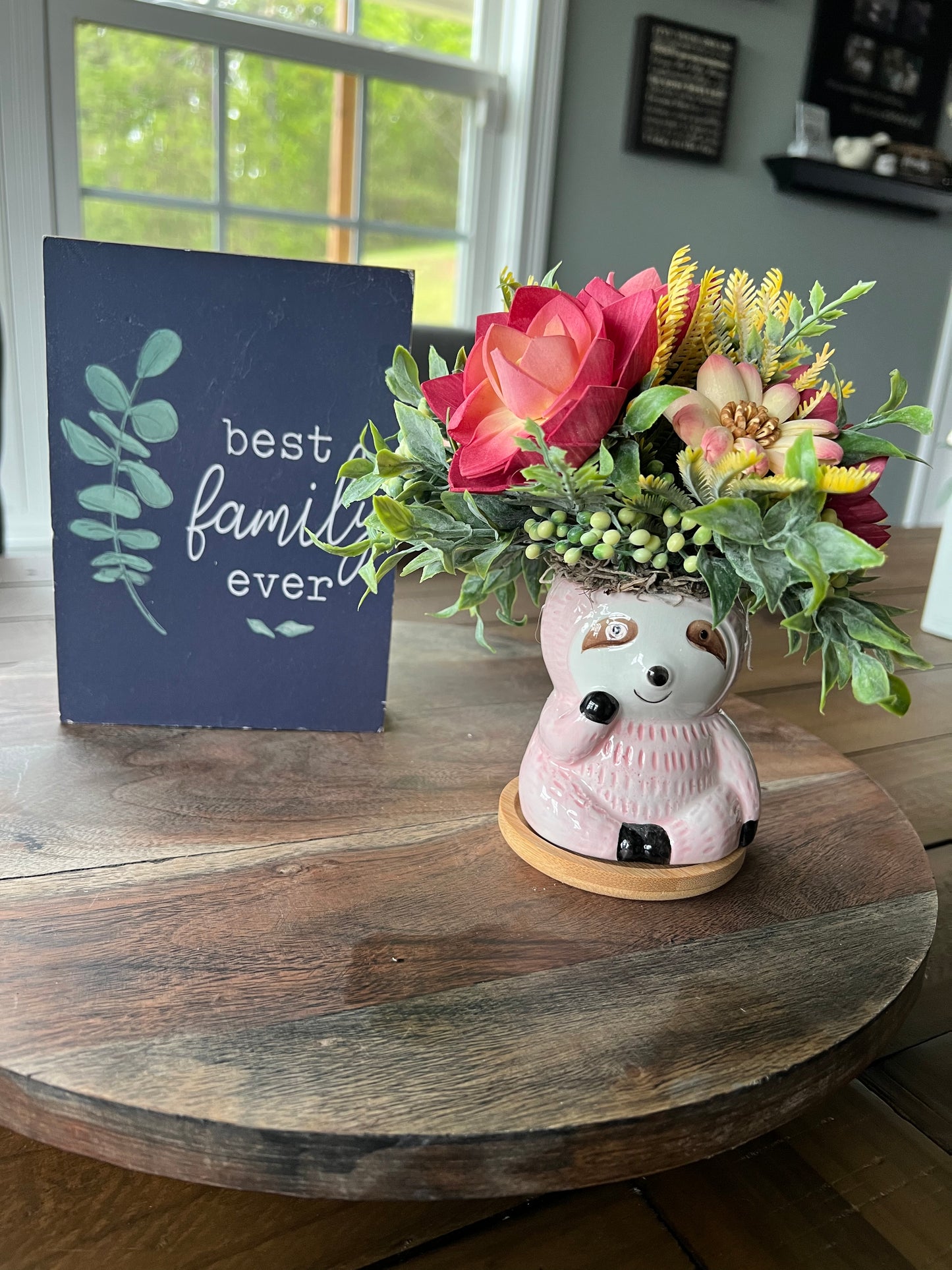 Pink Sloth with Pink and yellow flower arrangements